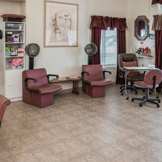 A cozy beauty salon with hair drying stations and comfortable seating.