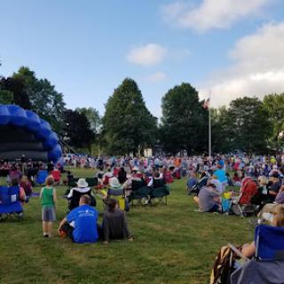 A lively concert event in a park, bringing the community together to enjoy music.