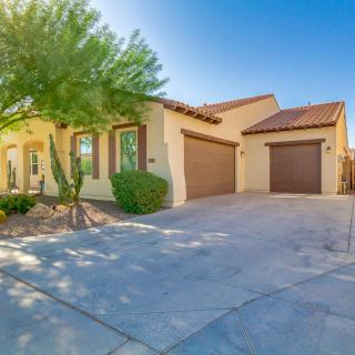 A suburban home with a spacious driveway and attached garages.