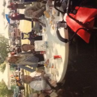 A group of people enjoying a summer picnic outdoors.