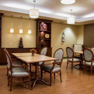 A well-lit dining area with elegant furniture and stylish decor.