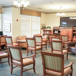 A cozy lounge area with arranged chairs and a television, ideal for group gatherings or relaxation.