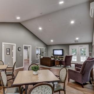 A spacious living room with modern furniture and a television.