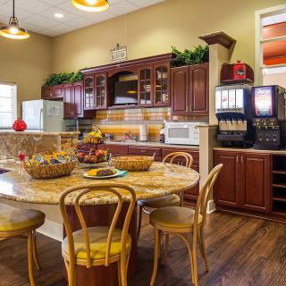 A cozy kitchen and dining area featuring wooden furniture and modern appliances.