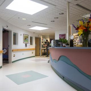 A bright and welcoming hospital reception area with a colorful design and fresh flowers.