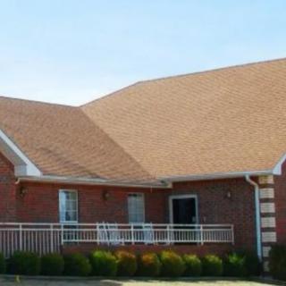 A brick house with a sloped roof and a front porch.