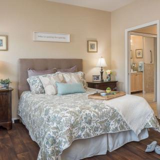 A cozy bedroom with elegant decor and a neatly made bed.