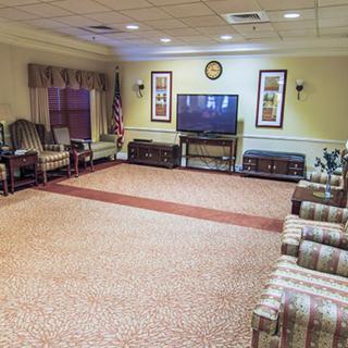 A cozy living room with ample seating and a large television.