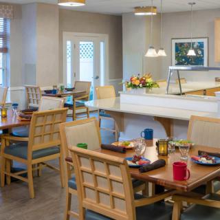 A cozy dining room with neatly arranged tables and chairs, ready for guests.