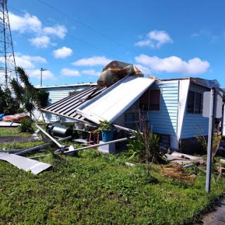 A house showing significant damage after a severe storm.