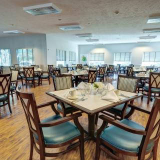 An elegant dining area with neatly arranged tables and chairs, ready for guests.