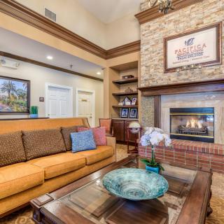 A cozy living room with a fireplace, comfortable sofa, and decorative elements.