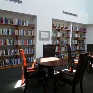 A quiet library reading area with bookshelves and seating.