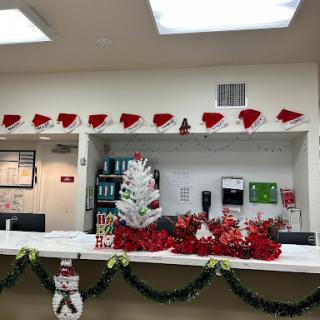 A festive front desk decorated for the holiday season with Christmas-themed ornaments.