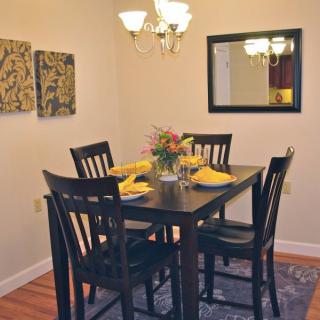 A cozy dining room with a neatly set table and warm lighting.