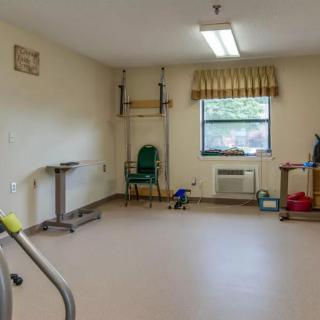 A rehabilitation room equipped with physical therapy tools and exercise equipment.