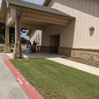 A sunny day outside a building with a welcoming entrance.