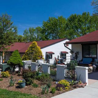 A charming residential home with a beautifully landscaped front yard and garden.