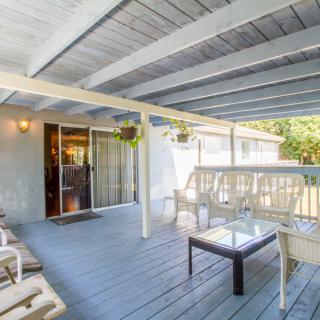A cozy outdoor patio with comfortable seating under a covered porch.