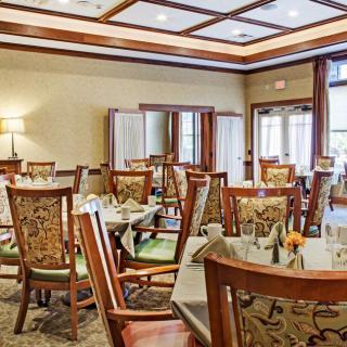An elegant dining room with neatly arranged tables and chairs.