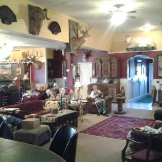 A traditional and cozy living room adorned with various decorative items and furniture.