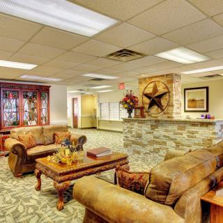 A well-furnished lobby with leather sofas and a decorative reception area.
