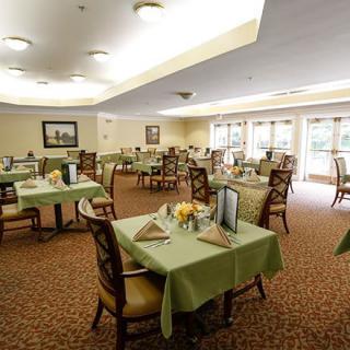 An elegantly decorated dining room with neatly arranged tables and chairs.