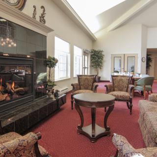 A spacious living room with a fireplace and comfortable seating arrangements.