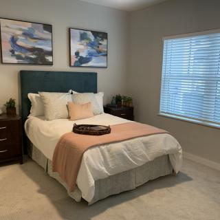A cozy bedroom with stylish decor and natural light.