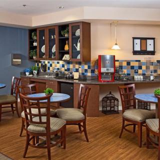 A cozy kitchen and dining area with wooden furniture and colorful tiles.