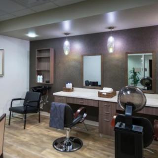 A modern hair salon interior with styling chairs and mirrors.