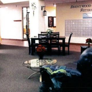 A cozy reception area with comfortable seating and a central dining table.
