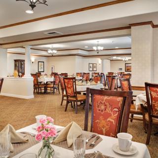 An elegant dining room with neatly arranged tables and chairs.