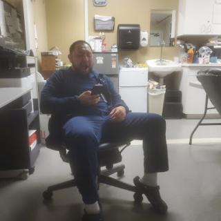 A man sitting comfortably in an office chair, enjoying a moment of relaxation in the workplace.