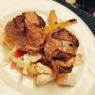 A delicious serving of grilled meat accompanied by a fresh salad.