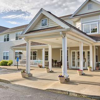A view of a residential building entrance with a covered porch area.
