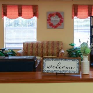 A cozy living room area featuring a welcoming ambiance with comfortable seating and decorative touches.
