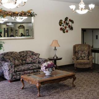 A cozy living room with floral furniture and classic decor.