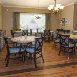 A cozy dining room with elegant furniture and lighting.