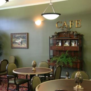 A cozy cafe interior with tables, chairs, and decorative elements.