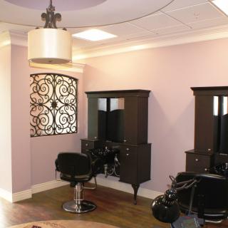 A modern hair salon interior with stylish decor and comfortable seating.