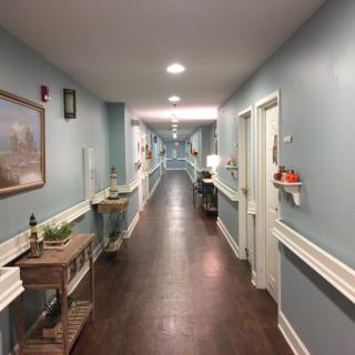 A well-lit, decoratively furnished hallway with multiple doors.