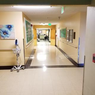 A clean and well-lit corridor in a hospital, showcasing the interior of a medical facility.