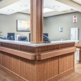 A wooden reception desk in an office setting.