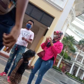 A family enjoys a day out in an urban setting, capturing moments together.