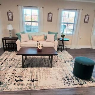 A cozy living room with a sofa, coffee table, and decorative cushions.