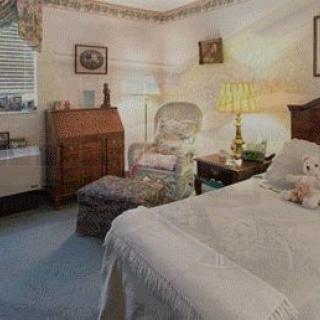 A cozy and inviting bedroom featuring classic furniture and soft lighting.