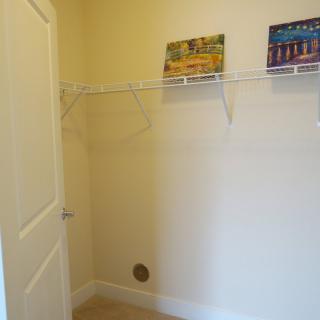 An empty closet with wire shelving installed along the walls.