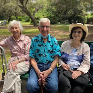 A joyful gathering of friends enjoying a sunny day at the park.