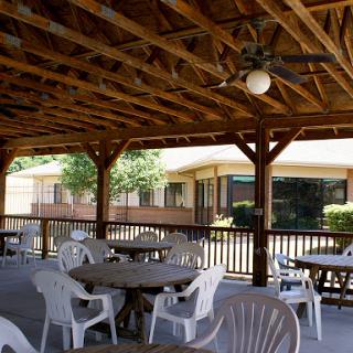 A spacious outdoor pavilion with tables and chairs, perfect for gatherings.